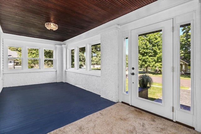 unfurnished sunroom with plenty of natural light and wooden ceiling