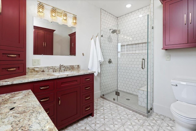 bathroom featuring a shower with shower door, vanity, and toilet