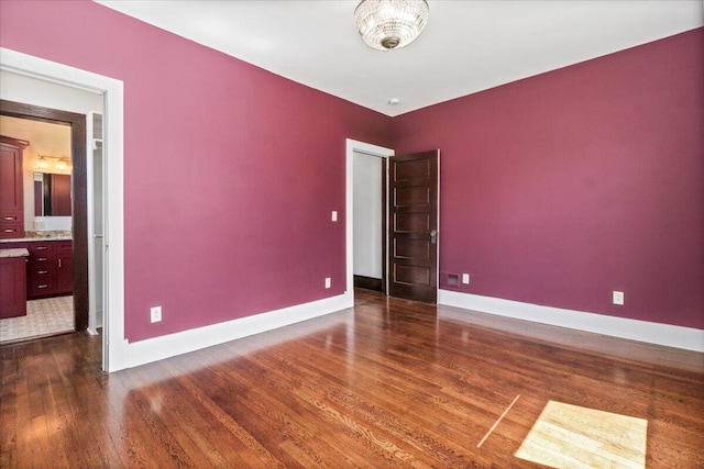 spare room featuring dark hardwood / wood-style flooring