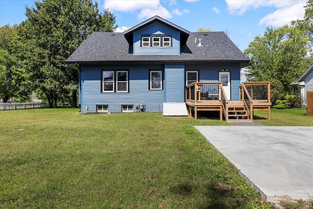 rear view of house with a lawn and a deck