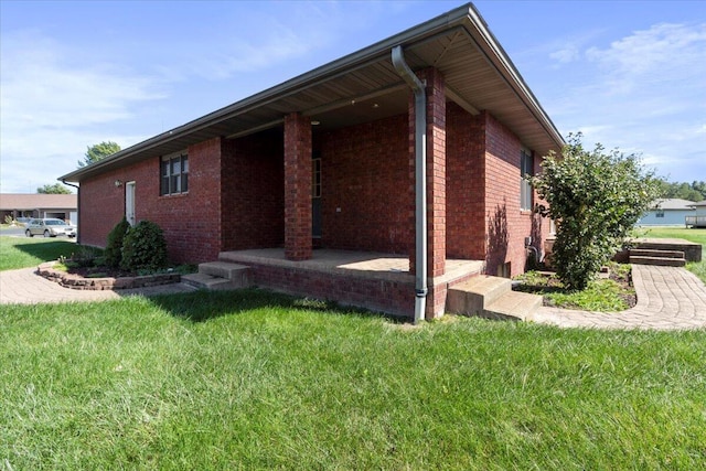 view of side of property with a yard