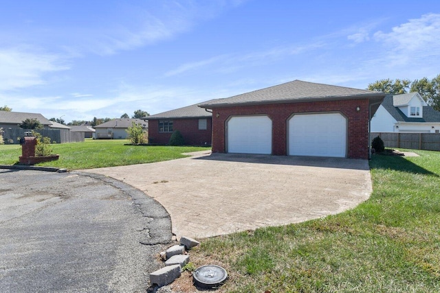 single story home featuring a front yard and a garage