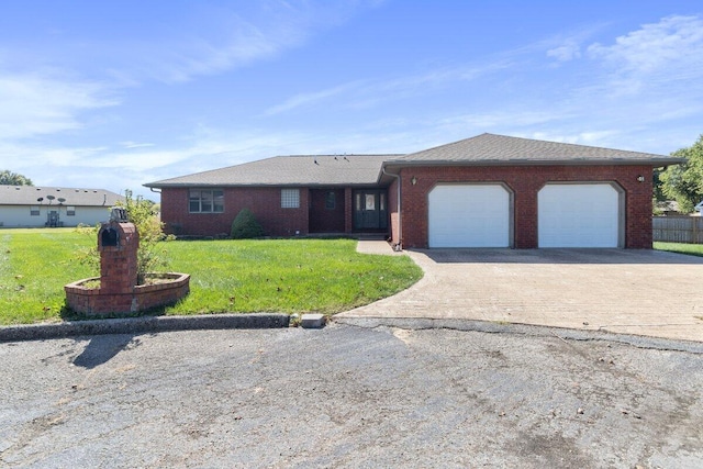 ranch-style house featuring a garage and a front yard