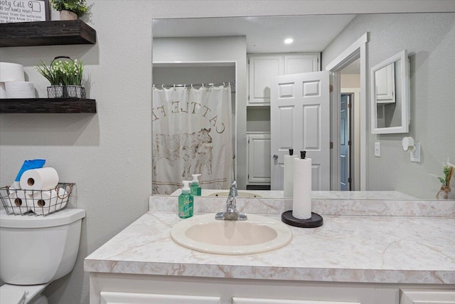 bathroom with toilet and vanity