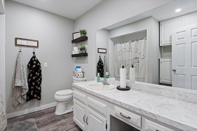 bathroom featuring hardwood / wood-style floors, toilet, and vanity