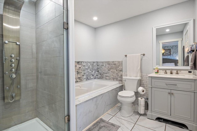 full bathroom with plus walk in shower, vanity, and toilet