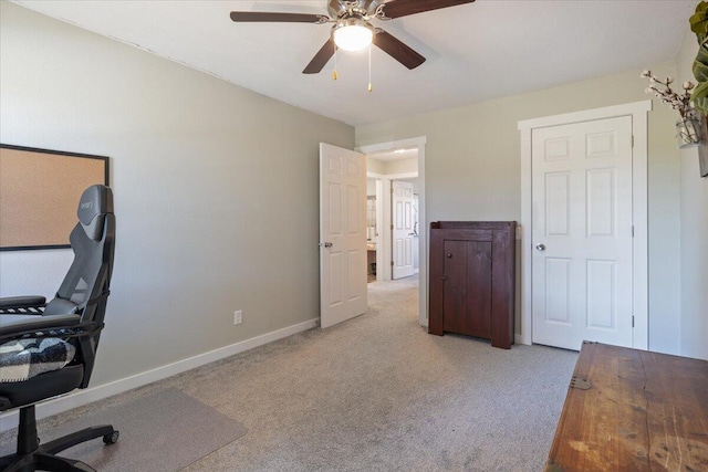 home office with ceiling fan and light colored carpet