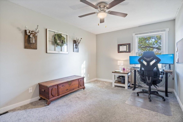 carpeted home office featuring ceiling fan