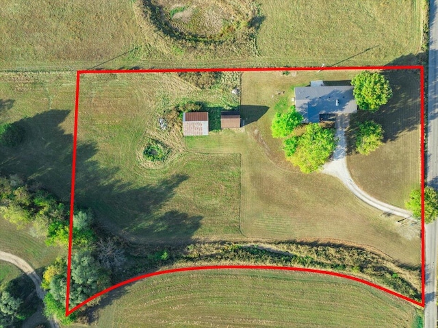 birds eye view of property with a rural view