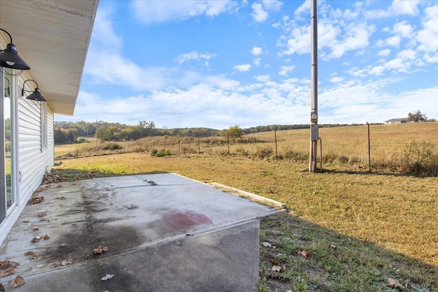 view of yard featuring a rural view and a patio