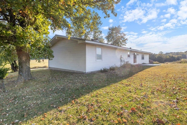 view of home's exterior with a yard