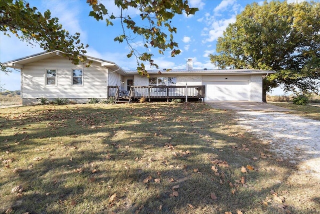 single story home with a garage, a front lawn, and a deck