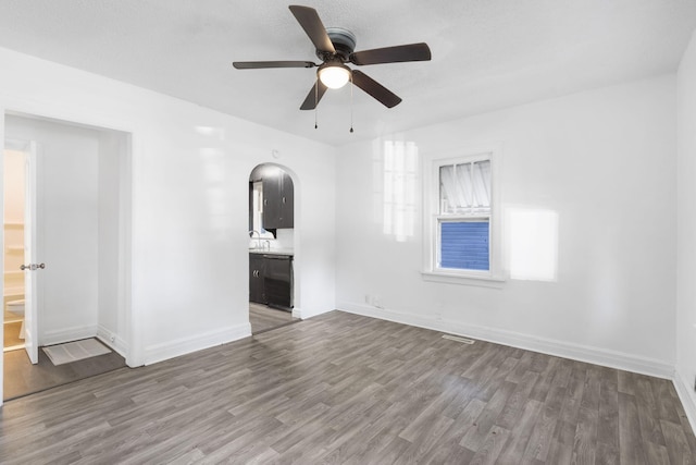 empty room with wood-type flooring and ceiling fan