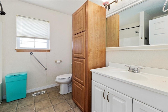 bathroom with walk in shower, vanity, and toilet