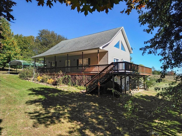 rear view of house with a lawn, a carport, and a wooden deck