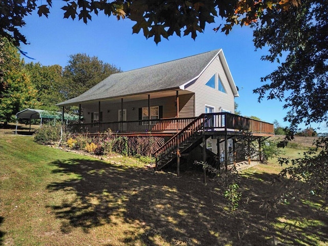back of house featuring a lawn, a deck, and stairway
