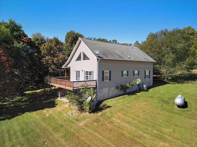 view of side of home with a yard, a wooden deck, and central air condition unit