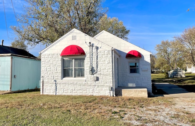 view of side of property with a yard