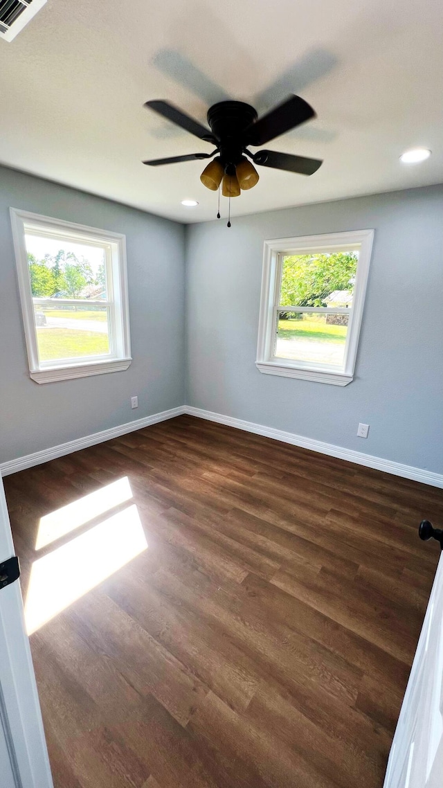 unfurnished room featuring recessed lighting, visible vents, a ceiling fan, baseboards, and dark wood-style flooring