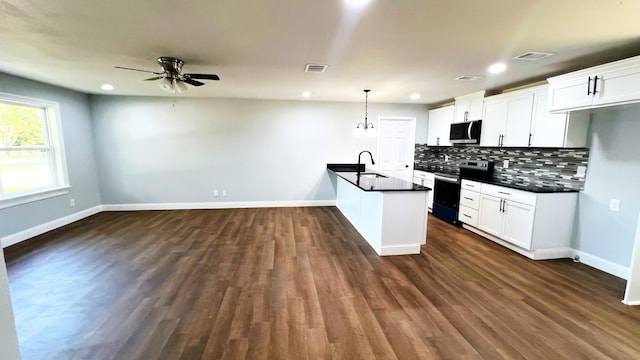 kitchen featuring a ceiling fan, dark countertops, tasteful backsplash, stainless steel appliances, and visible vents