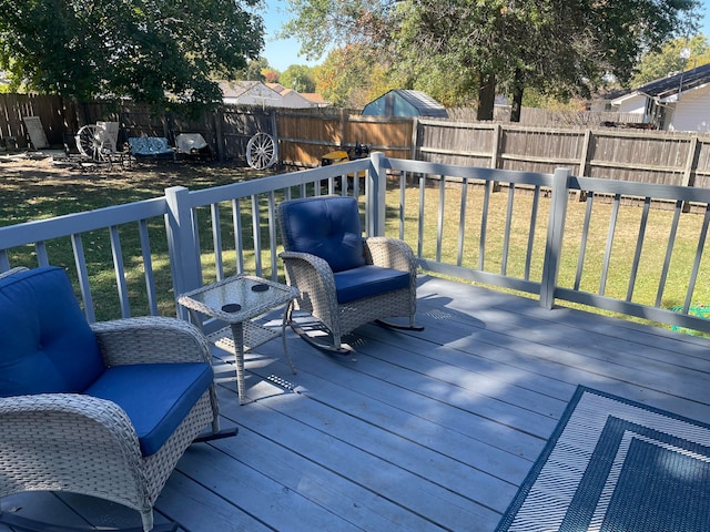 wooden terrace featuring a lawn