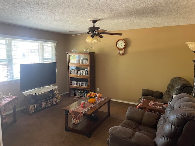 carpeted living room featuring ceiling fan and a textured ceiling