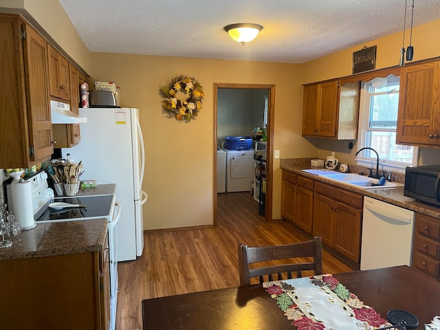 kitchen featuring a textured ceiling, washer and dryer, sink, and dishwasher