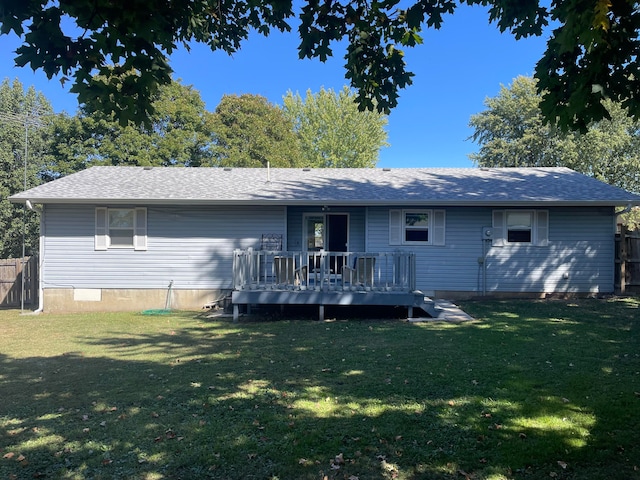 rear view of property featuring a yard and a deck