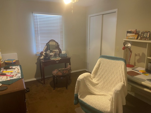 living area with dark colored carpet and ceiling fan