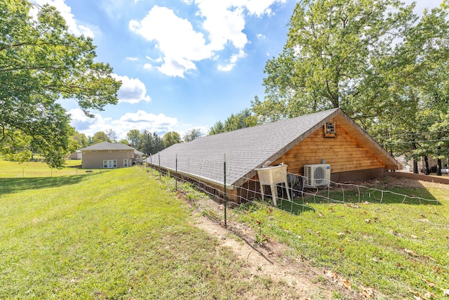 exterior space featuring a lawn and ac unit