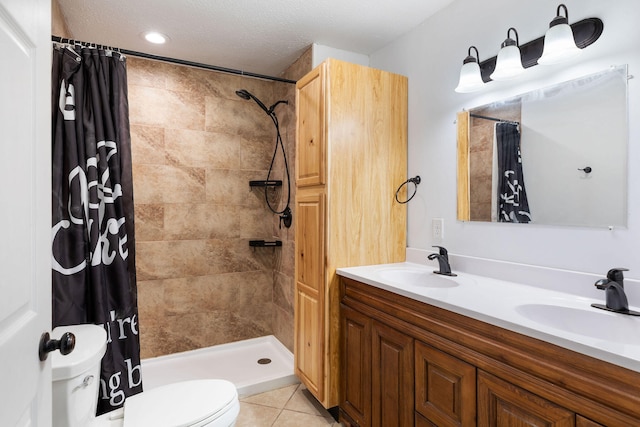 bathroom featuring walk in shower, tile patterned floors, a textured ceiling, toilet, and vanity