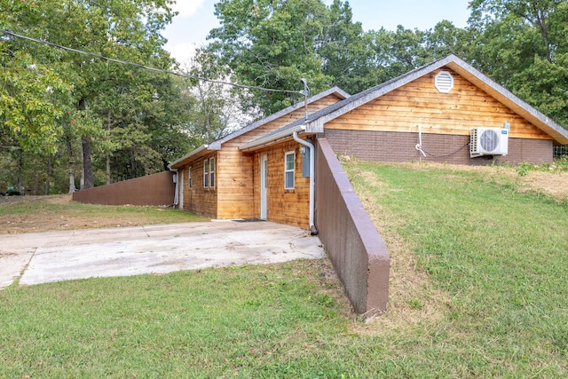 exterior space with ac unit and a yard