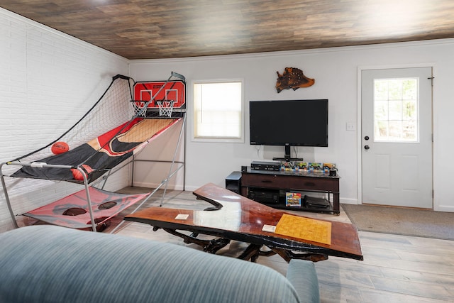 living room featuring wood ceiling, crown molding, brick wall, and light hardwood / wood-style flooring