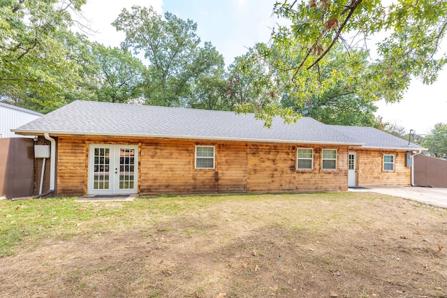 back of property featuring french doors and a yard