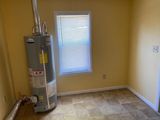 utility room featuring gas water heater