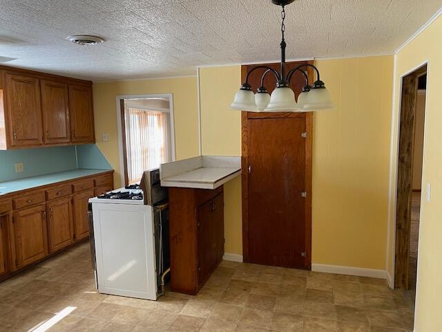 kitchen featuring pendant lighting, a notable chandelier, white range, and a textured ceiling