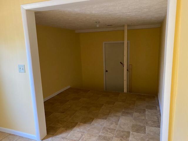 empty room featuring a textured ceiling