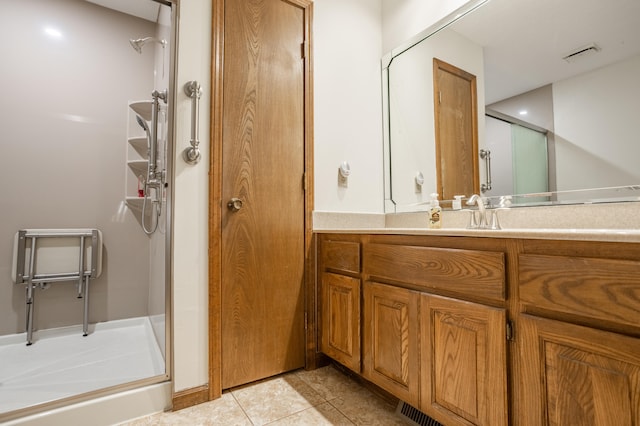 bathroom featuring vanity, tile patterned flooring, and an enclosed shower