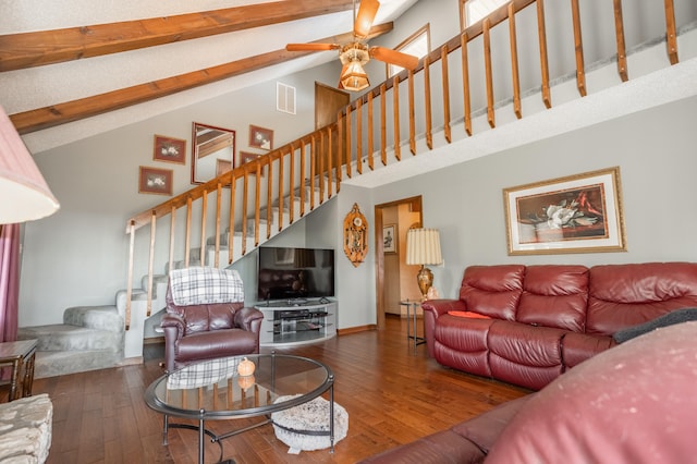 living room with a high ceiling, dark hardwood / wood-style flooring, and ceiling fan