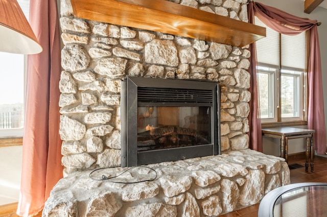 interior details with a stone fireplace and hardwood / wood-style floors