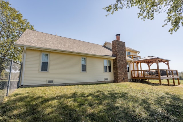 back of property with a gazebo and a yard