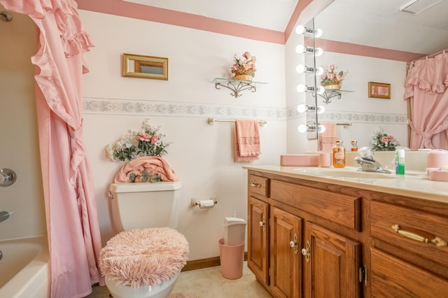 full bathroom with vanity, shower / bath combo with shower curtain, and toilet