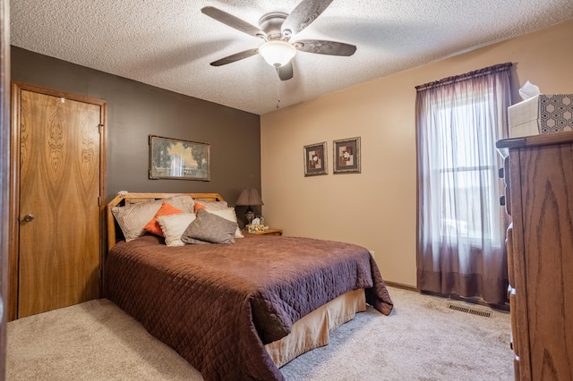 945 Ozark Rd, Nixa, MO 65714 - carpeted bedroom featuring a ceiling fan, visible vents, and a textured ceiling