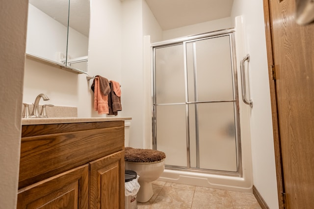 bathroom with tile patterned flooring, an enclosed shower, vanity, and toilet