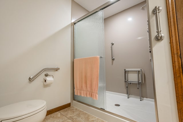 bathroom featuring walk in shower, tile patterned flooring, and toilet