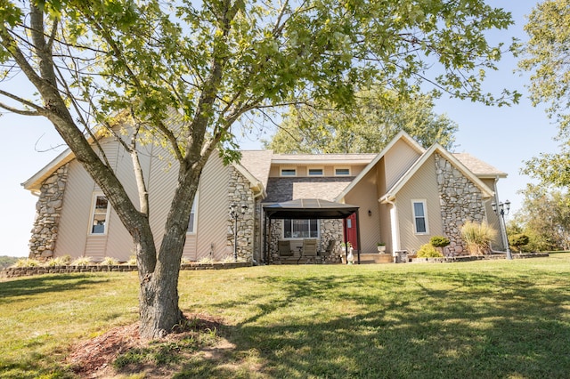 view of front of home with a gazebo and a front lawn