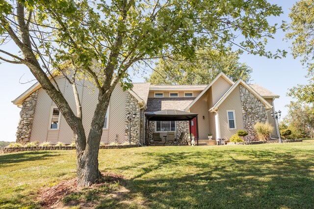 945 Ozark Rd, Nixa, MO 65714 - traditional home featuring a gazebo, stone siding, and a front lawn