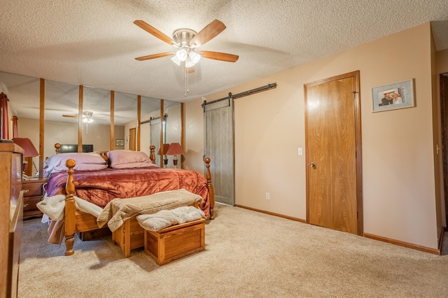 945 Ozark Rd, Nixa, MO 65714 - bedroom with a barn door, carpet flooring, and a textured ceiling
