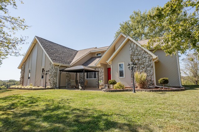 945 Ozark Rd, Nixa, MO 65714 - exterior space featuring a gazebo, roof with shingles, stone siding, and a front lawn