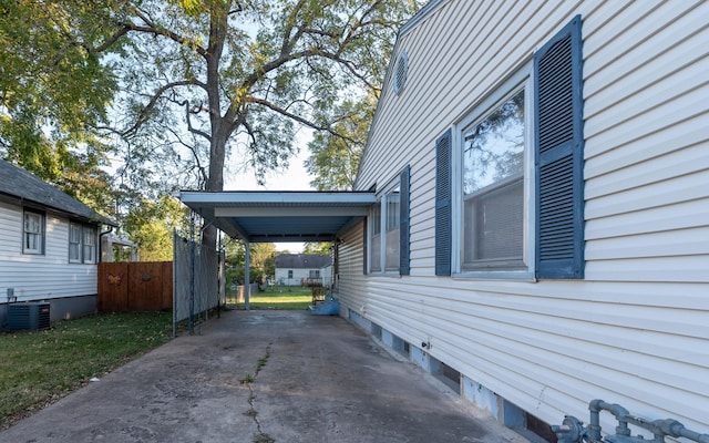 view of side of home featuring central air condition unit and a carport